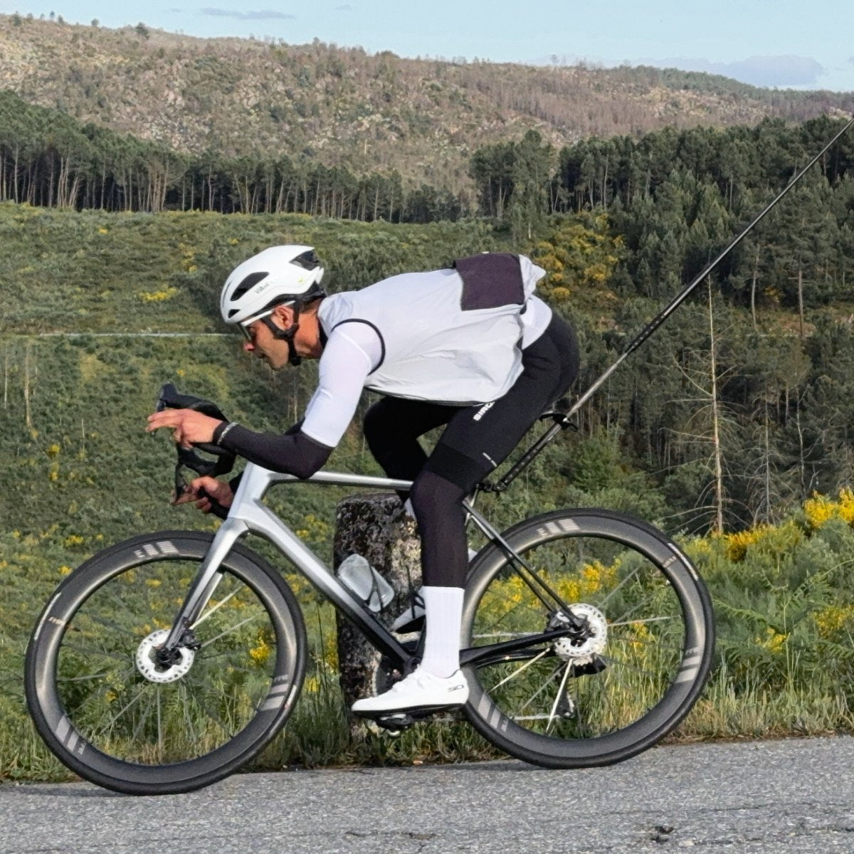 Road cyclist filming a ride with an Insta360 camera on a bike tail mount